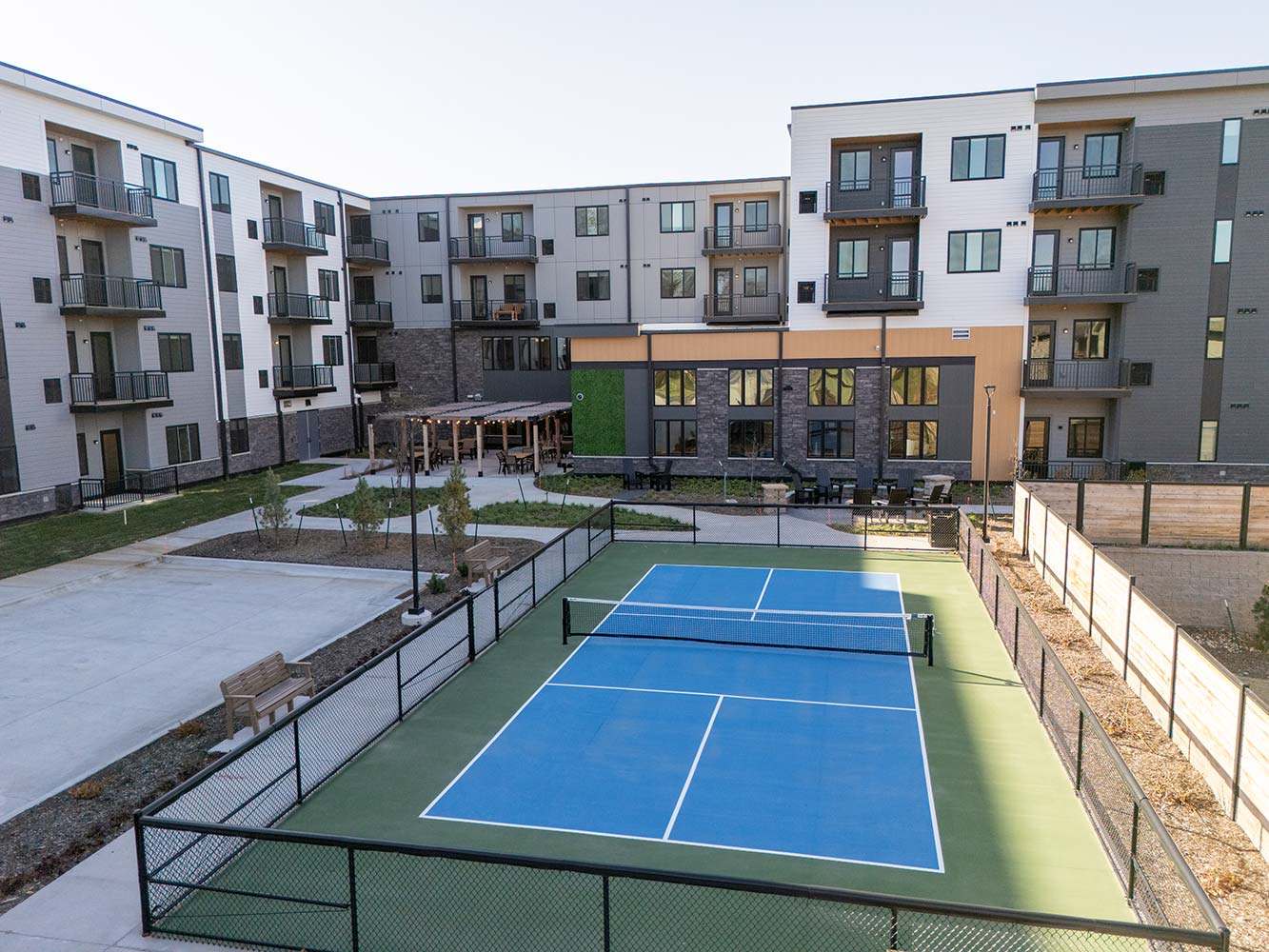 Exterior shot of Aura Independent Living featuring pickleball court.