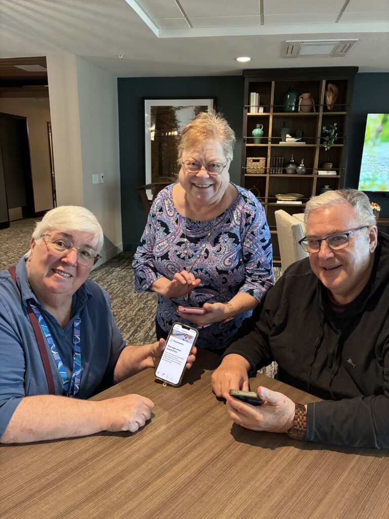 Resident ambassadors at Aura smile while enjoying the community app.